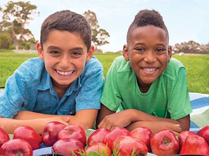 two boys with apples